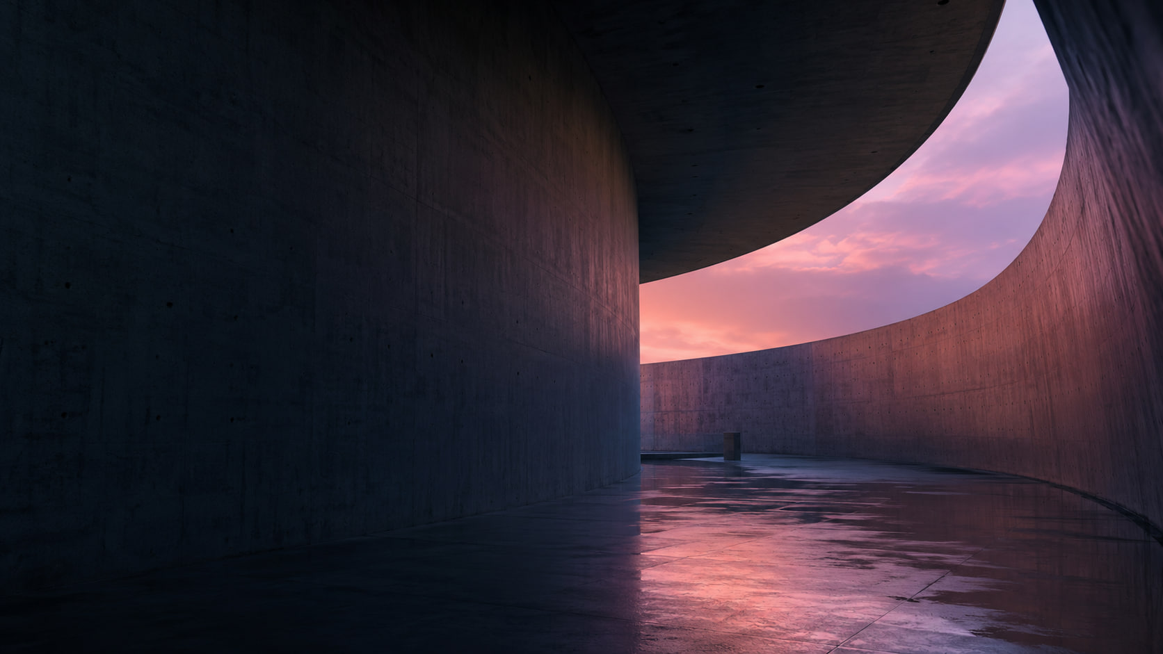 Curved concrete gallery at dusk
