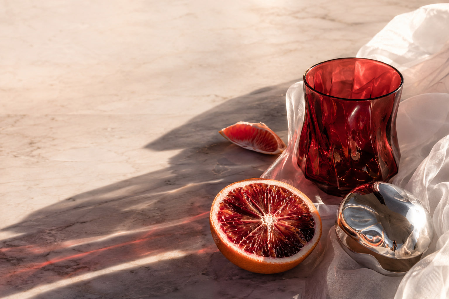 Warm still life with glass and citrus